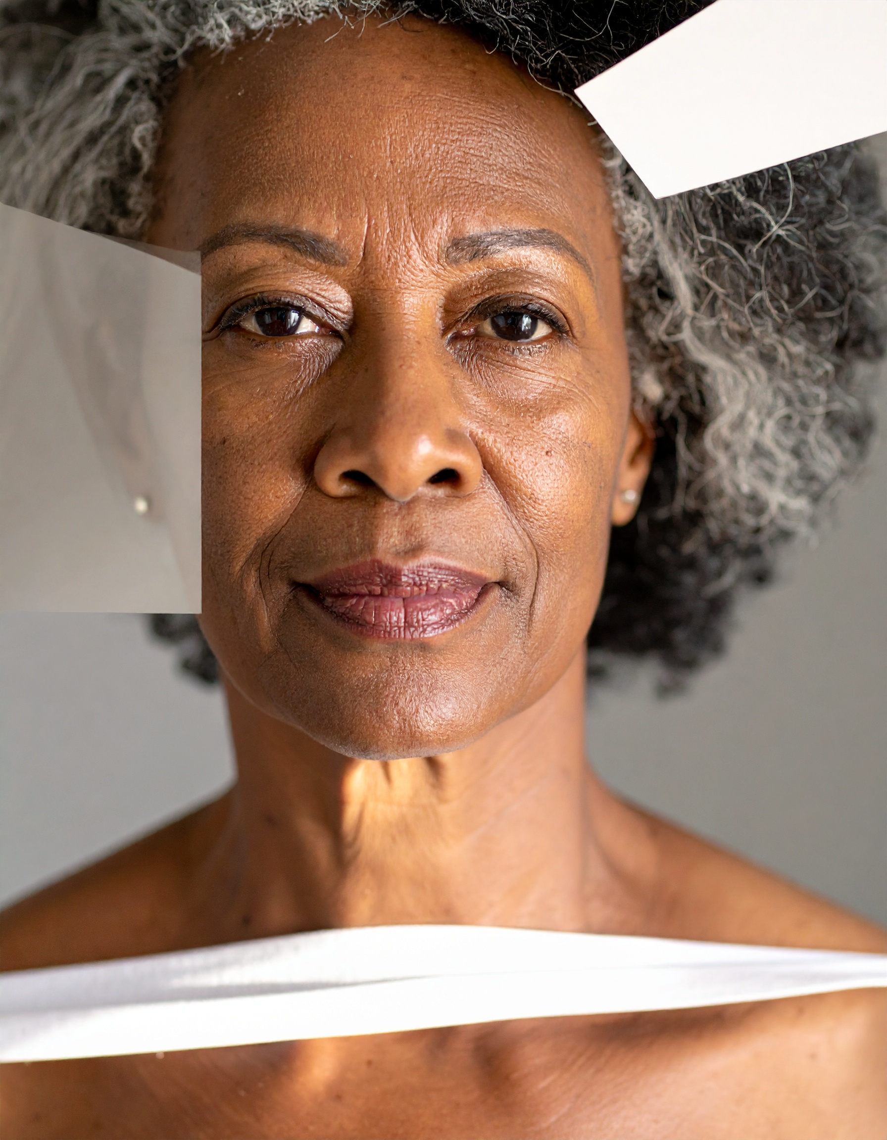 An elegant portrait of a mature woman with gray hair and expressive eyes